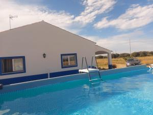 a villa with a swimming pool in front of a house at Quinta do Mocho by Portus Alacer in Arcos +33 photos