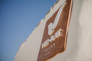 a sign on the side of a building at Venue Villas - Folegandros in Áno Meriá