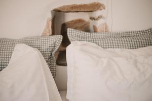 a bed with white sheets and pillows on it at Venue Villas - Folegandros in Áno Meriá