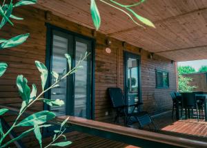 a screened porch of a house with chairs and a table at Tiny Otel Datca in Datca