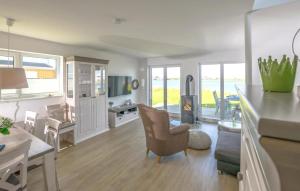 a living room with a kitchen and a dining room at Vogelvilla in Olpenitz +13 photos