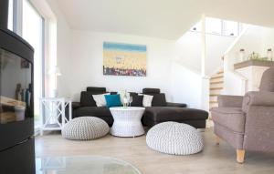 a living room with a couch and two chairs at Vogelvilla in Olpenitz