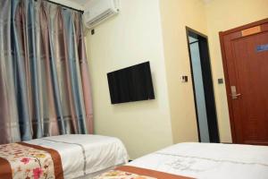 Letto o letti in una camera di Harbin Qiju Hotel Taiping International Airport