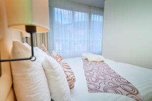 Ein Bett oder Betten in einem Zimmer der Unterkunft ASTORIA Hotel Opatija