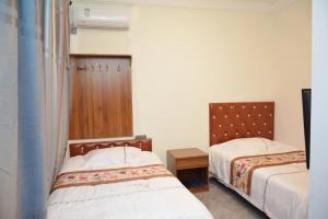 Letto o letti in una camera di Harbin Qiju Hotel Taiping International Airport