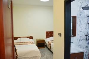Letto o letti in una camera di Harbin Qiju Hotel Taiping International Airport