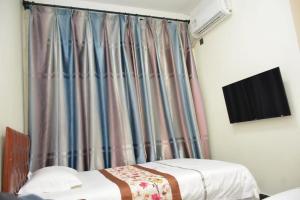 Letto o letti in una camera di Harbin Qiju Hotel Taiping International Airport