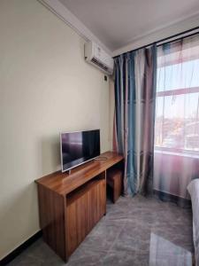 TV o dispositivi per l'intrattenimento presso Harbin Qiju Hotel Taiping International Airport