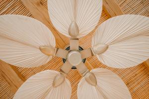 a ceiling fan with three umbrellas on it at Venue Villas - Folegandros in Áno Meriá