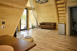 a living room with a couch and a refrigerator at Cabana A Vis in Taşca