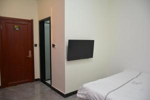 Letto o letti in una camera di Harbin Qiju Hotel Taiping International Airport