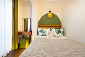 a bedroom with a bed with a green headboard at York House İstanbul in Istanbul