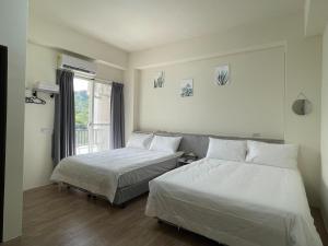 Ein Bett oder Betten in einem Zimmer der Unterkunft Hui Chao Gui Su