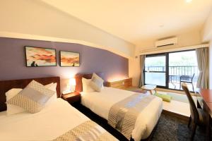 a hotel room with two beds and a window at Hotel Tokyo Trip Ueno Nishi Nippori in Tokyo