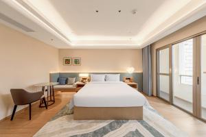 Postel nebo postele na pokoji v ubytování Tunchang Xiangshan Yunju Hotel