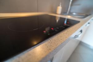 a black stove top oven sitting on top of a counter at AlbaChiara in Alghero