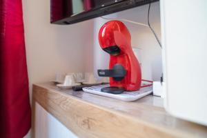 a red blender sitting on top of a counter at AlbaChiara in Alghero