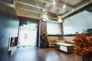 a living room with a couch and a table at Hotel Bhagyaraj Palace - Best Hotel In Kanpur in Kānpur