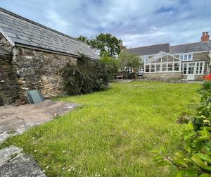 an exterior view of a house with a yard at Lower South Hill A Special Country House Near The Sea in Talbenny