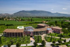 an aerial view of a campus with mountains in the background at Valle di Assisi Hotel & Spa in Assisi