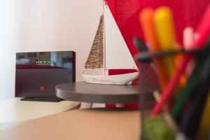 a toy boat sitting on a desk next to a computer at AlbaChiara in Alghero
