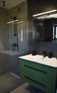 a bathroom with a sink and a mirror and a shower at Apartments Rismondi 37E in Fažana