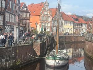 a boat docked in a canal in a city at Zeitapartments Am Fischmarkt in Stade