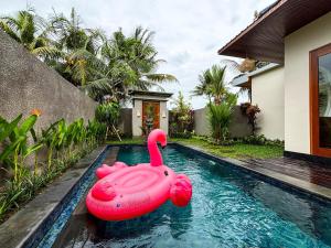 a pink inflatable flamingo in a swimming pool at Obah Villa Ubud 1 Br Brand new private villa in Ubud