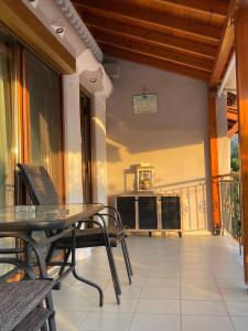 a patio with a table and chairs on a balcony at IslandTime Studio2 in Prinos