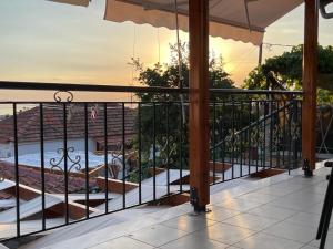 a balcony with an umbrella and a view at IslandTime Studio2 in Prinos