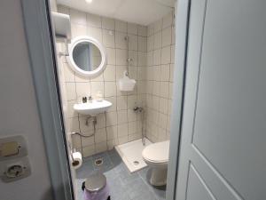 a small bathroom with a toilet and a sink at Chalkidonos in Heraklio Town +38 photos