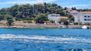 a view of a body of water with houses at Apartment Vjera in Tisno