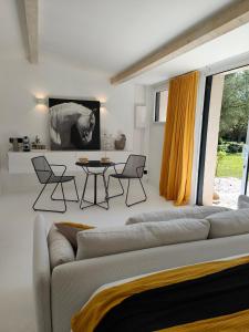 a living room with a couch and a table at La Maison l'Oliveraie in Lunel