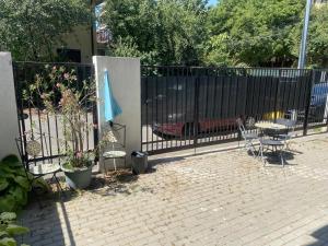 a wrought iron fence with a table and a patio at INC apartment in villa in Bucharest
