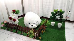 a garden with a white bear statue and potted plants at Apartment near Central Festival Hatyai in Hat Yai +135 photos