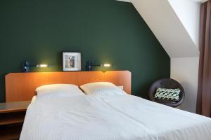 Postel nebo postele na pokoji v ubytování ACHAT Hotel Heppenheim