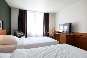 Postel nebo postele na pokoji v ubytování ACHAT Hotel Heppenheim