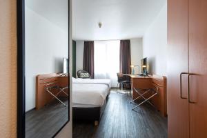 Postel nebo postele na pokoji v ubytování ACHAT Hotel Heppenheim