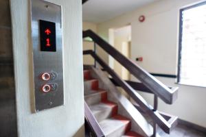 a close up of a set of stairs with a red button at Hadassah Hotel in Nairobi