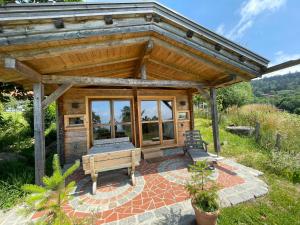 a wooden pavilion with a bench in a garden at Berghütte am Grandsberg in Schwarzach