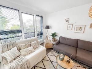 a living room with a couch and a table at Charme et confort à Bondy - proche Paris Disney CDG in Bondy