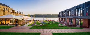 a patio with chairs and a hammock next to a building at Kurort Kameralny in Mikołajki