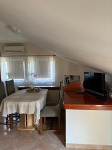 a kitchen with a table with a laptop on a counter at apartment IVA in Supetarska Draga