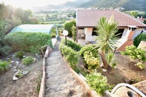 a house with a view of a garden at Villa giulia in Domus de Maria