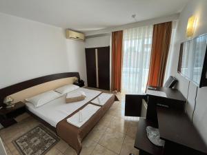 Postel nebo postele na pokoji v ubytování Hotel Metropol