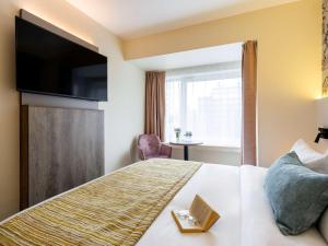 Кровать или кровати в номере Mercure Oostende