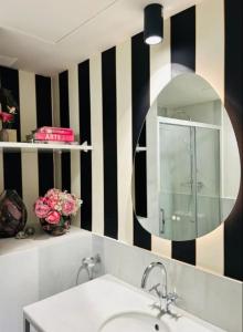 a bathroom with a sink and a mirror at Art Suite Granada in Granada +11 photos