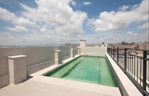 a swimming pool on the balcony of a house at Art Suite Granada in Granada