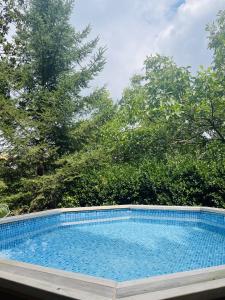 a swimming pool with trees in the background at ViLA VELLA 1 in Santa Pau