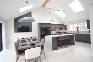 a kitchen and dining room with a table and chairs at Luxury holiday home with HOT TUB in St Merryn